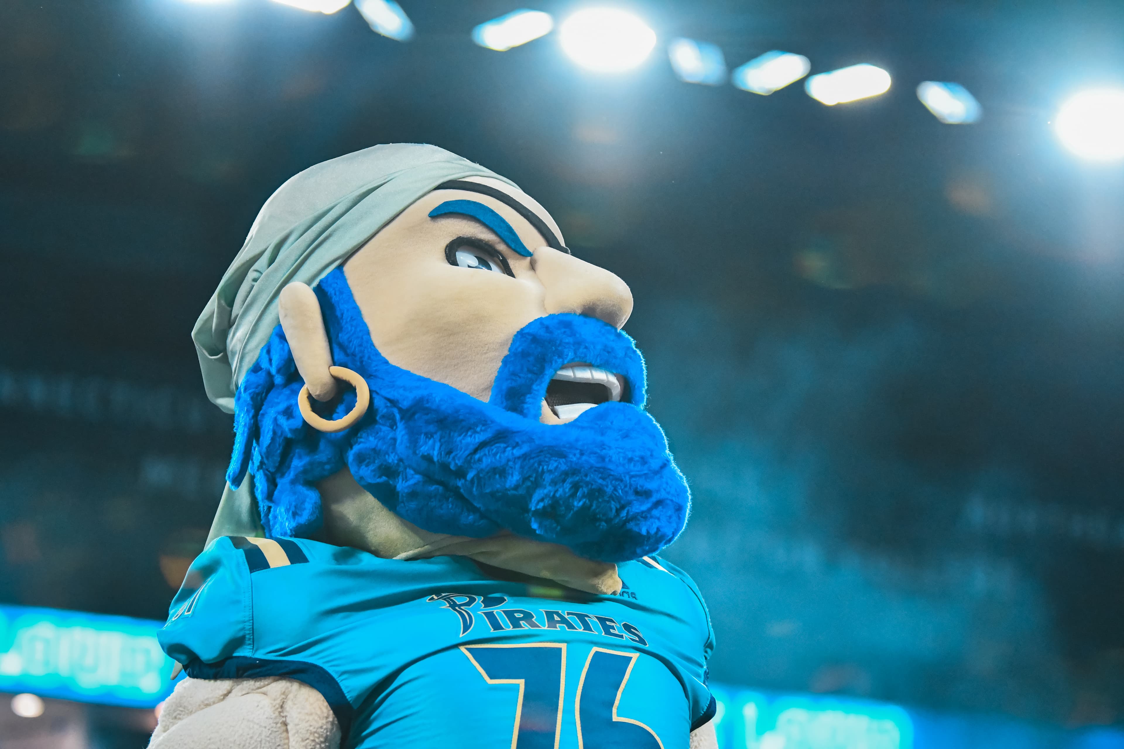 Pirates players on the field — celebration and connection during indoor football action.
